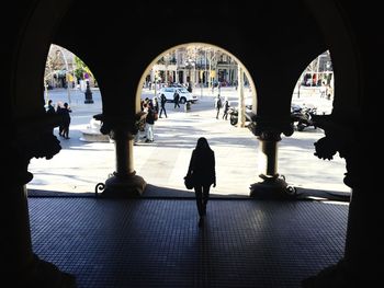 Rear view of silhouette people walking in city