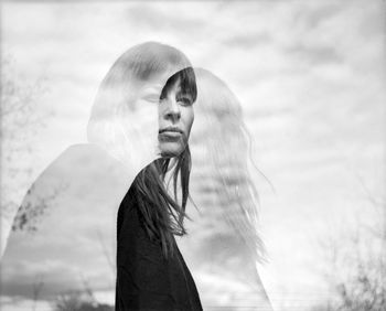 Double exposure of woman against sky
