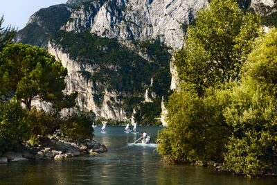 Scenic view of lake garda with surfing people