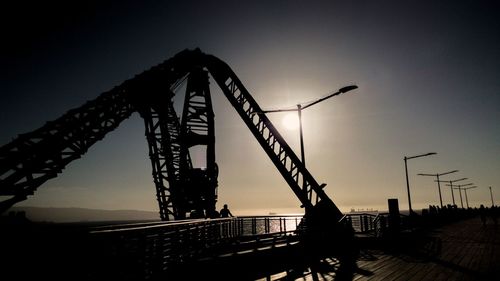 Silhouette of crane against sky at night