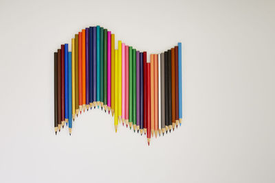 Close-up of multi colored pencils against white background