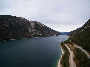 Scenic view of sea and mountains against sky