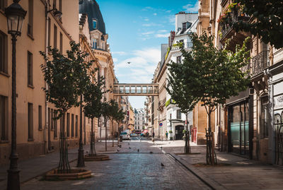 Street amidst buildings against sky