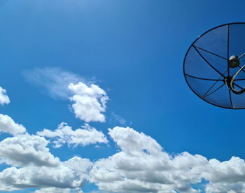 Low angle view of telephone pole against blue sky