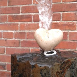 Close-up of heart shape on brick wall