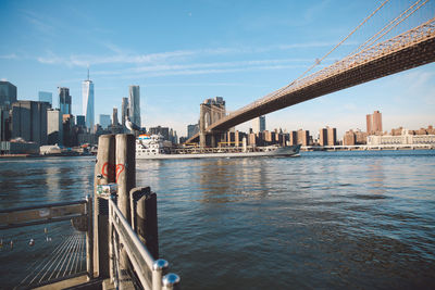 Bridge over river with city in background