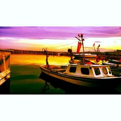 Boats moored in lake against sky during sunset