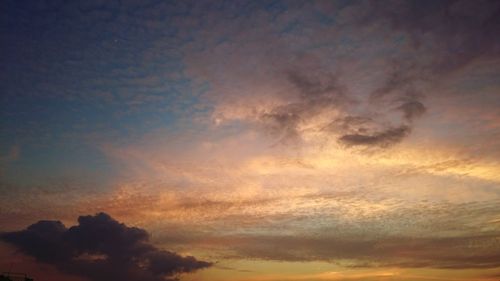 Low angle view of cloudy sky at sunset