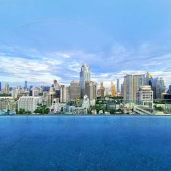 Buildings in city against blue sky