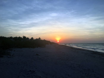 View of calm beach at sunset