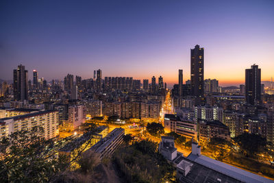 High angle view of illuminated buildings against sky during sunset