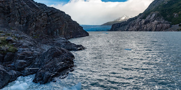 Scenic view of sea and mountains against sky