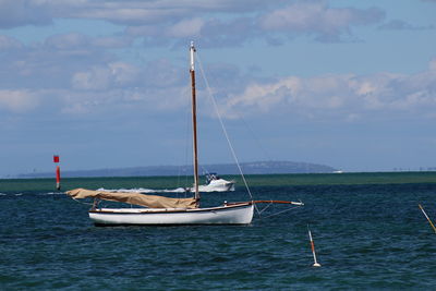 Sailboat on sea against sky