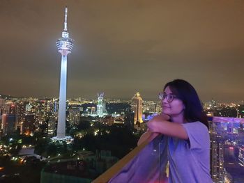 High angle view of illuminated buildings against sky at night