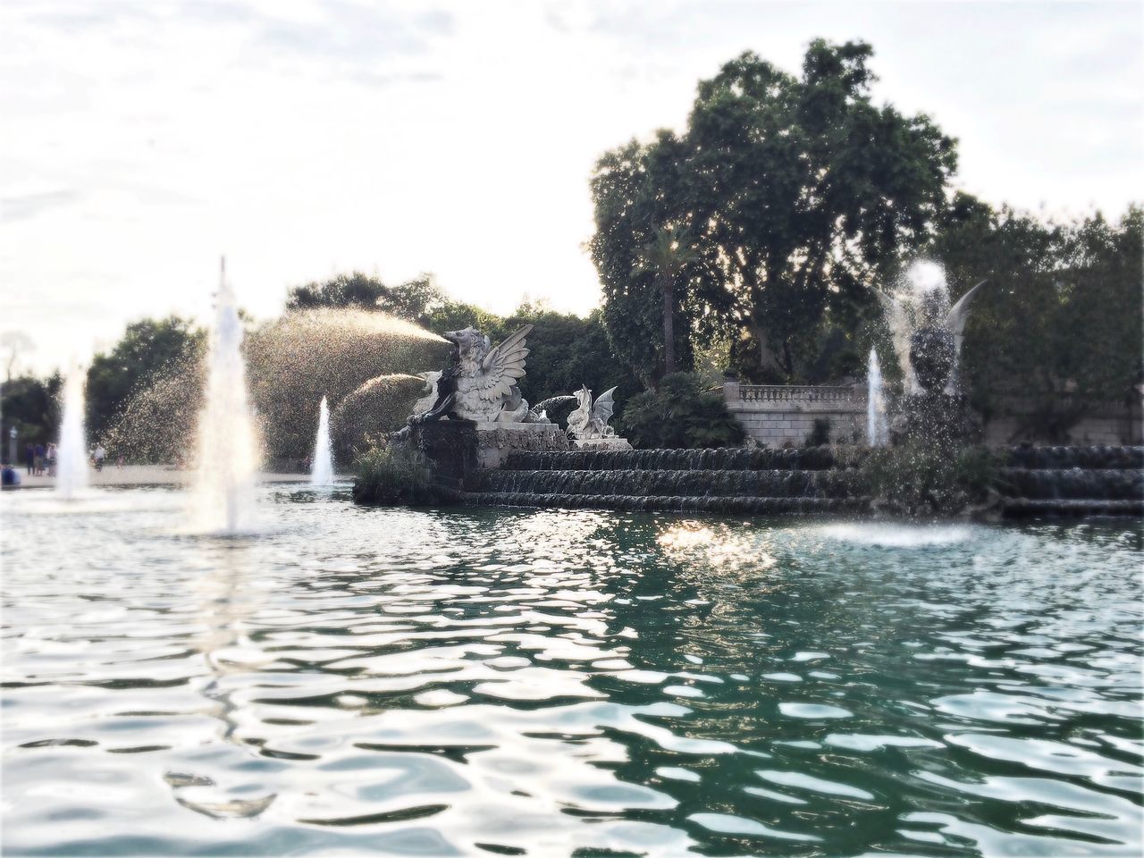 FOUNTAIN ON LAKE AGAINST SKY