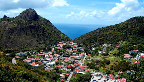 High angle view of townscape by sea against sky