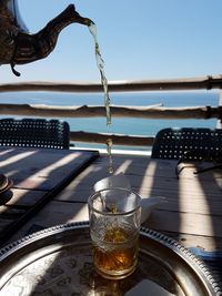 Traditional way to serve thé in morocco. thé in motion in front of the sea