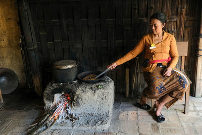 Full length of woman having food