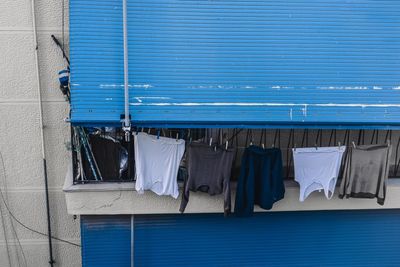 Clothes drying against blue sky