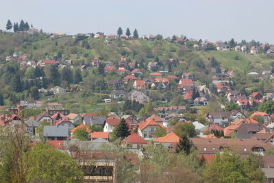 High angle view of houses in town against clear sky