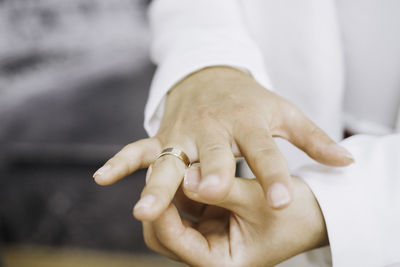 Cropped image of couple holding hands