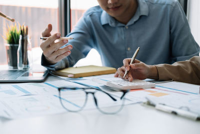 Midsection of business colleagues working at office