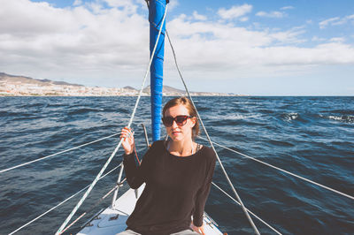 Portrait of young woman sitting in boat on sea