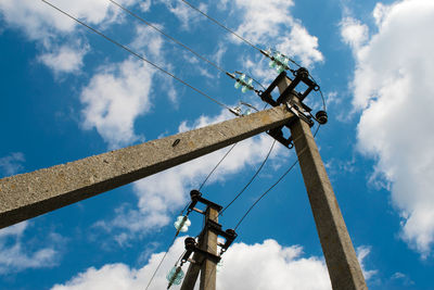 Low angle view of cranes against sky