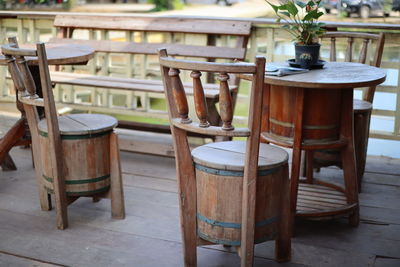 Empty chairs and tables at sidewalk cafe