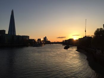 View of buildings at waterfront during sunset