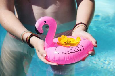 Close-up of person holding toy in swimming pool