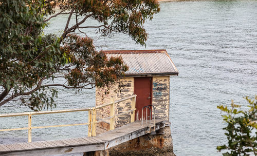 Built structure by lake against building