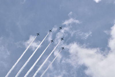 Low angle view of airshow against sky