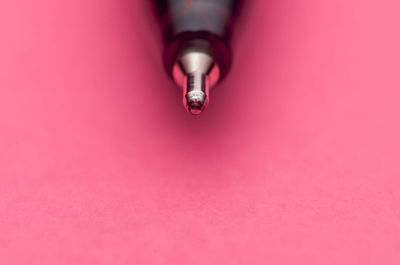 High angle view of pen on pink background