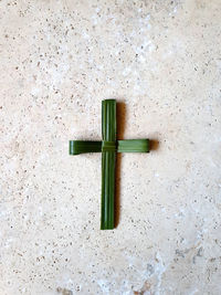 High angle view of cross on table