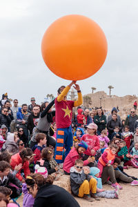 High angle view of people with balloons against sky