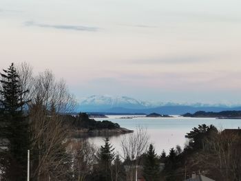 Scenic view of lake against sky at sunset