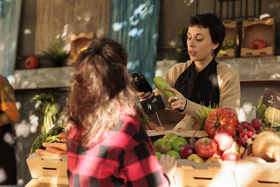 Portrait of young woman holding food at home