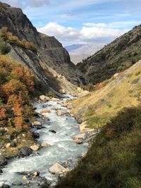 Scenic view of river amidst mountains against sky