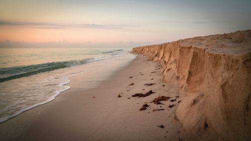 Scenic view of beach against sky during sunset