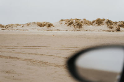 Sand dunes in desert against clear sky