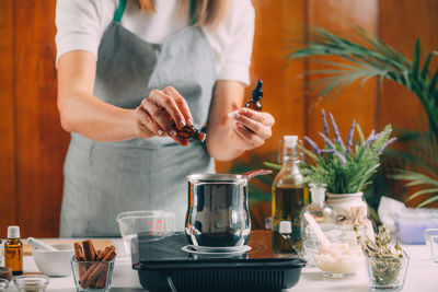 Midsection of woman holding food on table