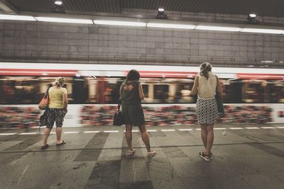 Full length of woman standing at railroad station