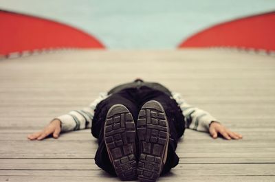 Man lying on boardwalk