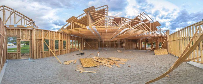 View of construction site by building against sky