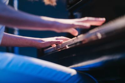 Close-up of hands playing piano