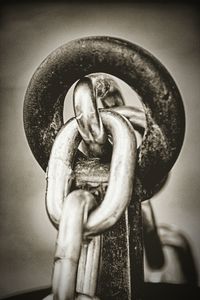 Close-up of rusty chain hanging on metal door