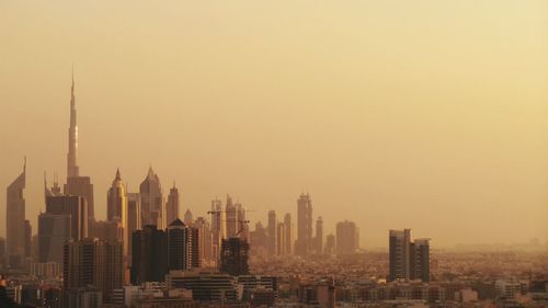 Cityscape against sky during sunset