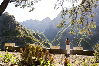 Rear view of man looking at mountains