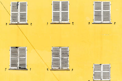 Low angle view of yellow windows on building